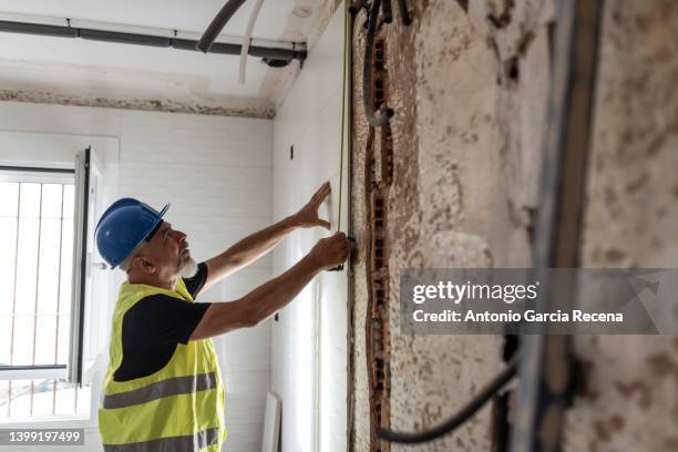 construction worker prepares the kitchen tiles in a home renovation - renovering bildbanksfoton och bilder