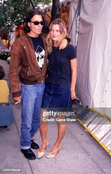 Portrait of American actor Johnny Depp and British model Kate Moss as they pose together on a sidewalk in the West Village, New York, New York,...