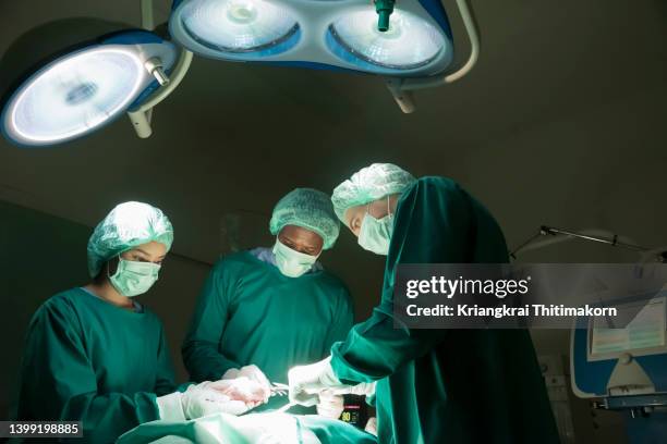 surgeons are performing heart transplant operation for a senior patient. - surgeon stock pictures, royalty-free photos & images