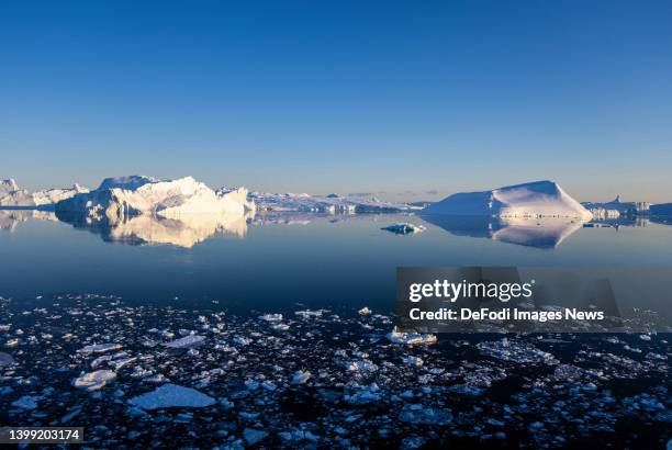 Ilulissat, Greenland Icebergs, calved from the Sermeq Kujalleq glacier, float in the Ilulissat Icefjord. 2022 will mark one of the biggest ice melt...