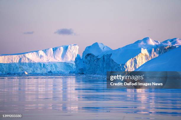 Ilulissat, Greenland Icebergs, calved from the Sermeq Kujalleq glacier, float in the Ilulissat Icefjord. 2022 will mark one of the biggest ice melt...