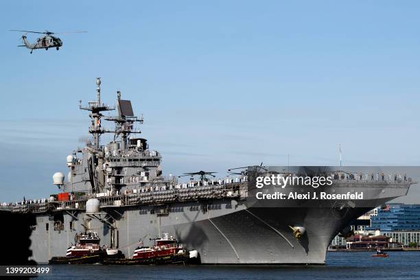 Coast Guard helicopet casts a shadow on the USS Bataan during their arrival for Fleet Week 2022 as seen from the Intrepid Museum on May 25, 2022 in...