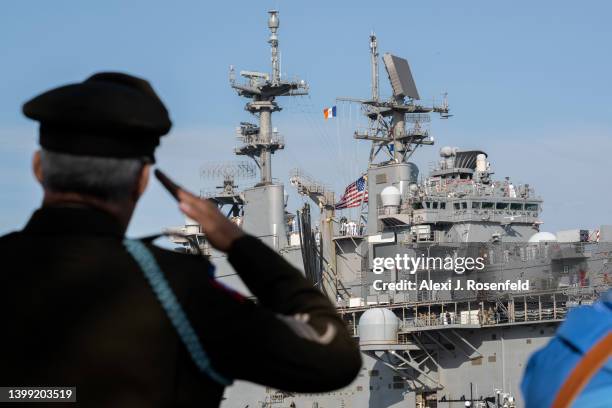 Army Staff Sgt. Banjamin Marrero salutes as Marines and Navy sailors from the USS Bataan stand on the flight deck during their arrival for Fleet Week...