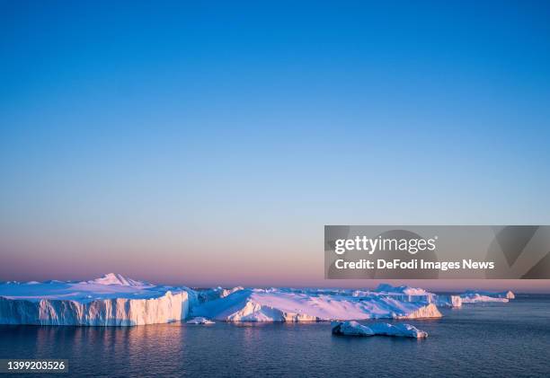 Ilulissat, Greenland Icebergs, calved from the Sermeq Kujalleq glacier, float in the Ilulissat Icefjord. 2022 will mark one of the biggest ice melt...