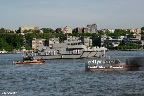 Coast Guard vessels patrol as one of the USNA YP's arrives for Fleet Week 2022 as seen from the Intrepid Museum on May 25, 2022 in New York City....