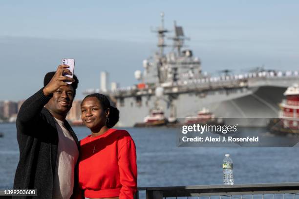 People take a selfie with the USS Bataan arriving for Fleet Week 2022 as seen from the Intrepid Museum on May 25, 2022 in New York City. Fleet Week...