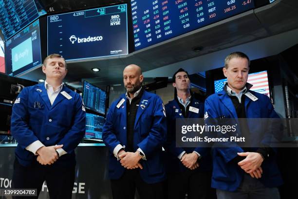 Traders participate in a moment of silence at the start of the trading day for the victims of the school shooting in Texas on the floor of the New...