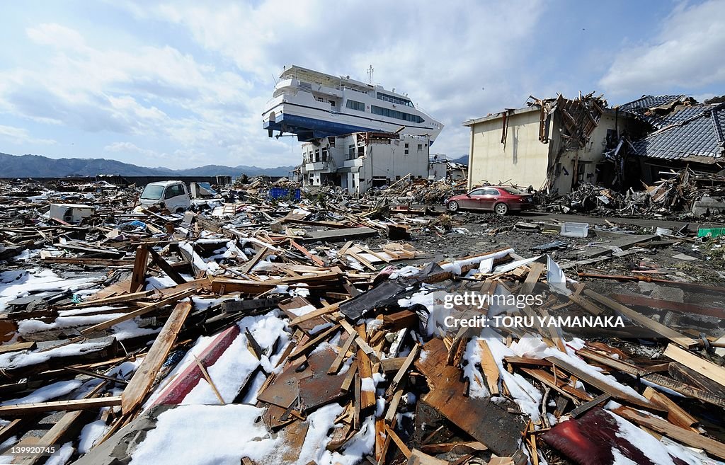 A cruise ship lies on the roof of a two