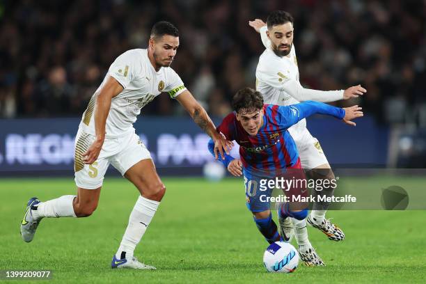 Gavi of FC Barcelona Is tackled by Jack Rodwell of the All Stars during the match between FC Barcelona and the A-League All Stars at Accor Stadium on...