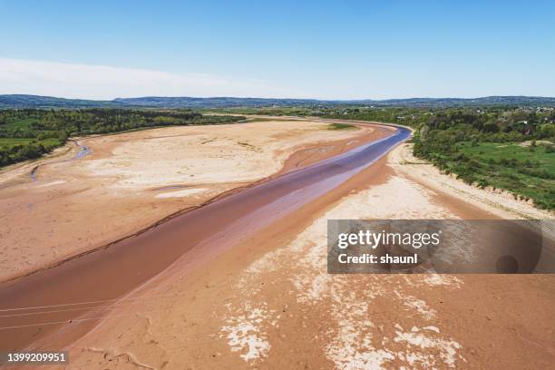 dry riverbed - mud riverbed stock pictures, royalty-free photos & images