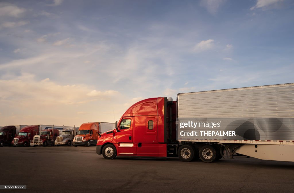 BIg red semi trailer entering a truk stop resting area in Utah, USA