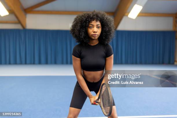 portrait of a young african woman playing tennis on court - tennis quick imagens e fotografias de stock