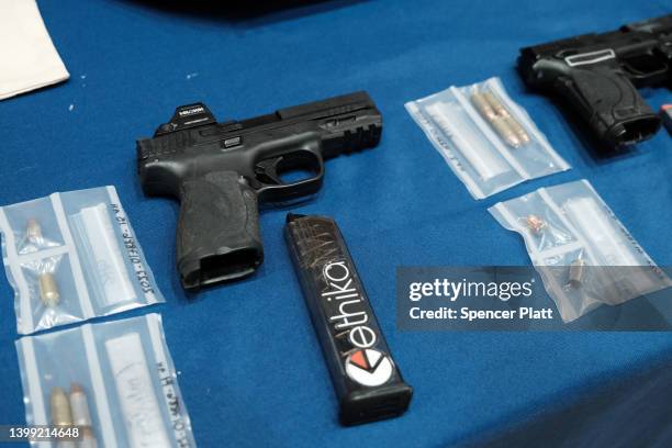 Guns confiscated at New York City public schools are displayed at a news conference with Mayor Eric Adams at police headquarters to speak about guns...