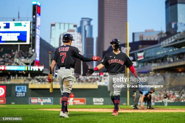 Austin Hedges of the Cleveland Guardians and Myles Straw against the Minnesota Twins on May 13, 2022 at Target Field in Minneapolis, Minnesota.