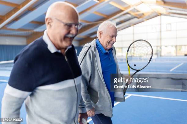 mature men playing tennis on an indoor court - 80s tennis players stock pictures, royalty-free photos & images