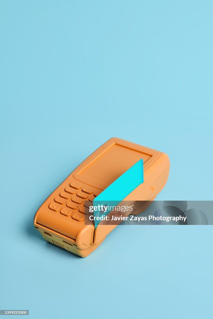 Orange Credit card POS terminal On Blue Background