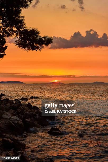 sun setting over adristic sea in supetar, brac island, croatia - brac eiland stockfoto's en -beelden