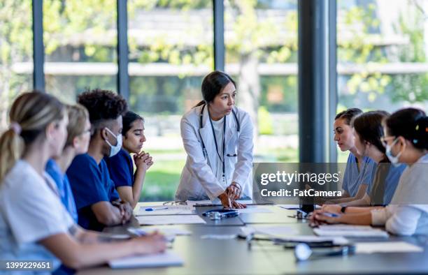 medical residence team meeting - diversity team clinic stock pictures, royalty-free photos & images