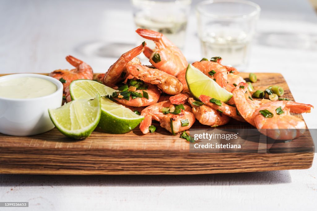 Spicy shrimp on cutting board, shrimp cocktail. Sunlight with harsh shadows