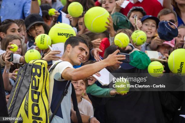 May 25. Carlos Alcaraz of Spain takes a selfie for a fan after his dramatic five set victory against Albert Ramos-Vinolas of Spain on Court Simonne...