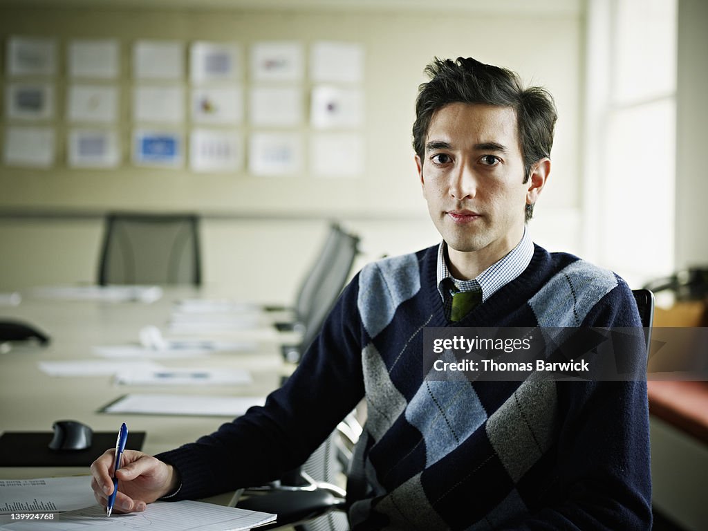 Portrait of businessman seated at conference table
