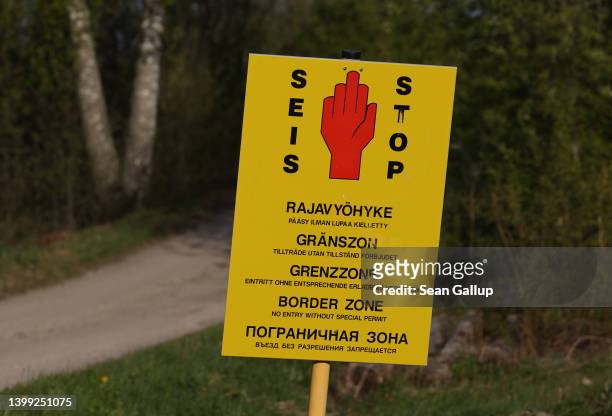 Sign warns visitors not to proceed further near the Finnish-Russian border at Räikkölä on May 25, 2022 near Imatra, Finland. Commercial activity...