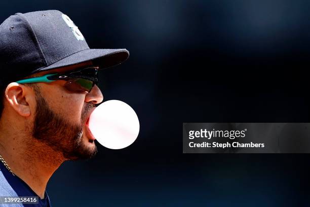 Eugenio Suarez of the Seattle Mariners blows a bubble during the second inning against the Oakland Athletics at T-Mobile Park on May 25, 2022 in...