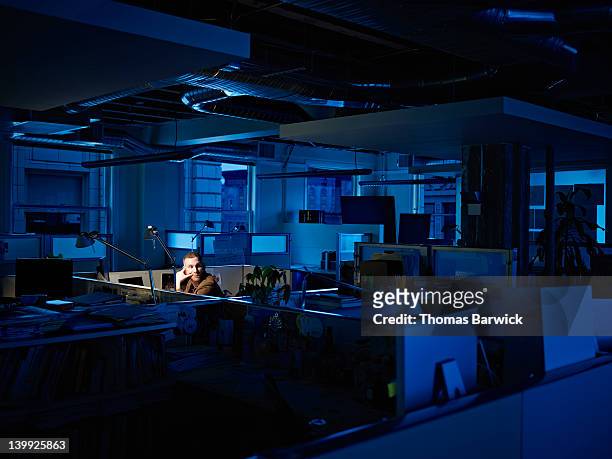 businessman working late at desk in office - solitude stock pictures, royalty-free photos & images