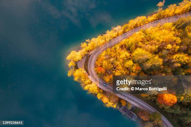 coastal road on emerald lake in autumn - slovenia lake stock pictures, royalty-free photos & images