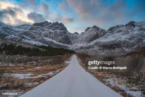 scenic road covered with snow in winter, lofoten islands, norway - covered car street stock pictures, royalty-free photos & images