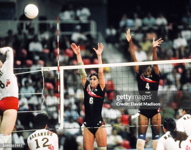 Kim Oden and Paula Weishoff of the USA block during a volleyball match against Japan on July 29, 1992 during the 1992 Summer Olympics at the Palau...