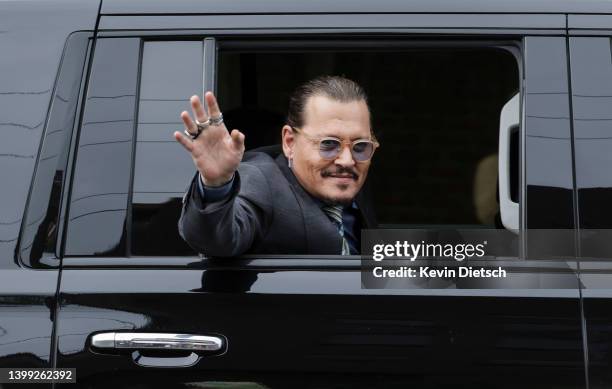 Actor Johnny Depp waves to supporters as he leaves the Fairfax County Courthouse on May 25, 2022 in Fairfax, Virginia. The Depp v. Heard, a...