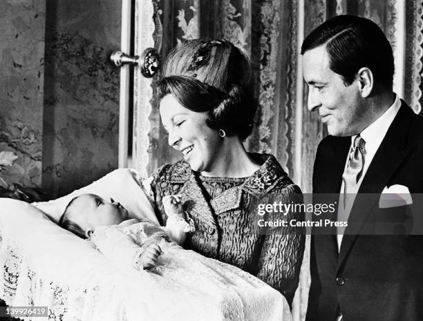 Prince Claus of the Netherlands and Princess Beatrix of the Netherlands with their second son, Prince Friso of Orange-Nassau, after his christening...