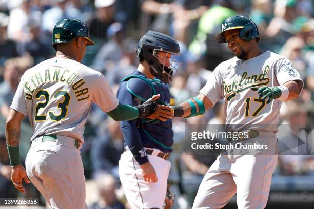 Elvis Andrus of the Oakland Athletics celebrates his two run home run with Christian Bethancourt during the sixth inning against the Seattle Mariners...