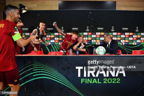 Jose Mourinho celebrates with Edoardo Bove and Gianluca Mancini of AS Roma in the post match press conference after their sides victory during the...