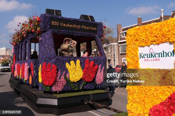 Woman performs in a float with a design of a bus with tulips of Keukenhof during the 75th Bloemencorso, a flower parade, on April 23, 2022 in...