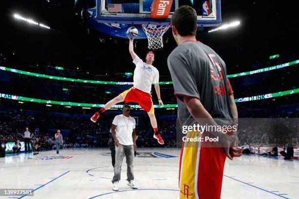 Chase Budinger of the Houston Rockets jumps over entertainer Sean "P.Diddy" Combs during the Sprite Slam Dunk Contest part of 2012 NBA All-Star...