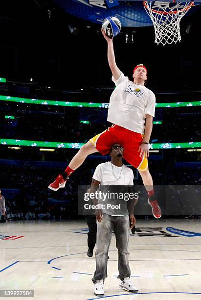 Chase Budinger of the Houston Rockets jumps over entertainer Sean "P.Diddy" Combs during the Sprite Slam Dunk Contest part of 2012 NBA All-Star...