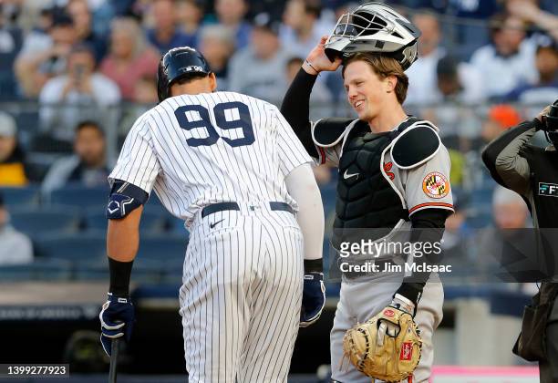 Adley Rutschman of the Baltimore Orioles talks with Aaron Judge of the New York Yankees in the first inning at Yankee Stadium on May 25, 2022 in New...