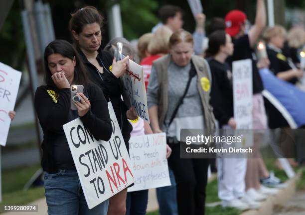 Gun-control advocates hold a vigil outside of the National Rifle Association headquarters following the recent mass shooting at Robb Elementary...