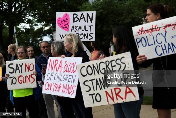 Gun-control advocates hold a vigil outside of the National Rifle Association headquarters following the recent mass shooting at Robb Elementary...