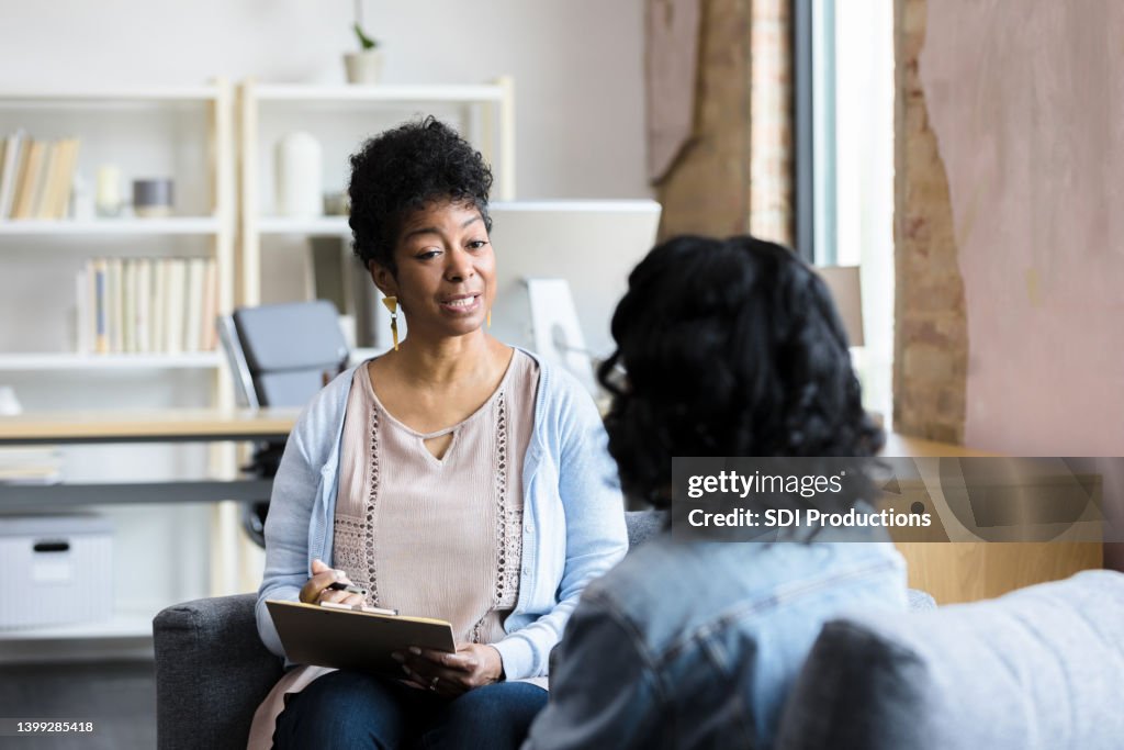 Mature female counselor gives unrecognizable young woman advice