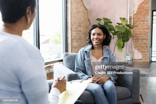 young woman smiles while answering therapist's questions - alternative therapy bildbanksfoton och bilder