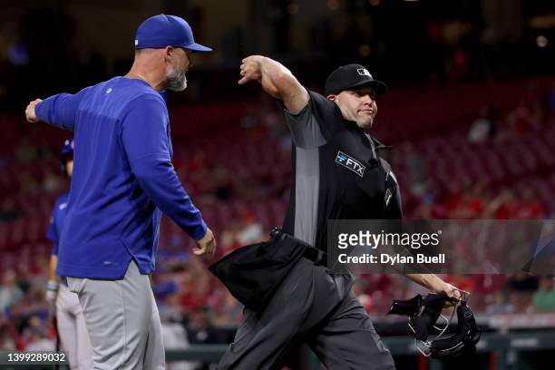 Umpire Dan Merzel ejects Manager David Ross of the Chicago Cubs in the ninth inning against the Cincinnati Reds at Great American Ball Park on May...