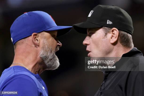 Manager David Ross of the Chicago Cubs and umpire Chris Conroy argue after Ross was ejected in the ninth inning against the Cincinnati Reds at Great...
