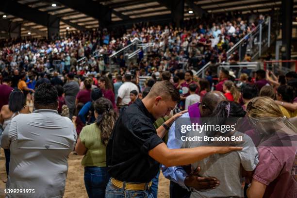 Community members pray together at a vigil for the 21 victims in the mass shooting at Robb Elementary School on May 25, 2022 in Uvalde, Texas....