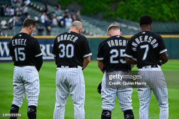 Adam Engel, Jake Burger, Andrew Vaughn and Tim Anderson of the Chicago White Sox bow their heads in a moment of silence for the victims of the mass...