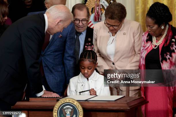 Gianna Floyd, the daughter of George Floyd, holds a pen used by U.S. President Joe Biden to sign an executive order enacting further police reform in...