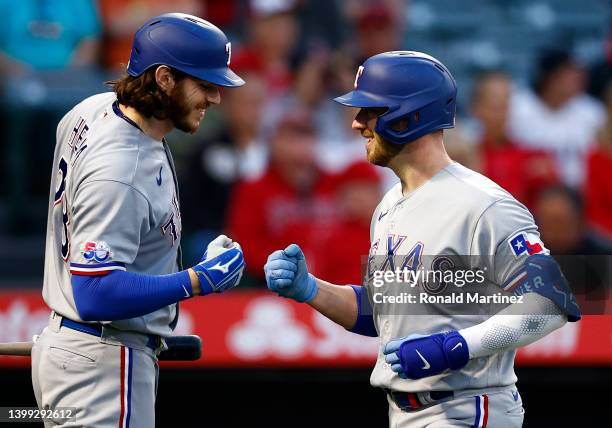 Mitch Garver of the Texas Rangers celebrates a home run with Jonah Heim of the Texas Rangers against the Los Angeles Angels in the fourth inning at...