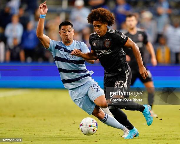 Adalberto Carrasquilla of Houston Dynamo fends off Roger Espinoza of Sporting Kansas City during the second half of their match in the Round of 16 of...